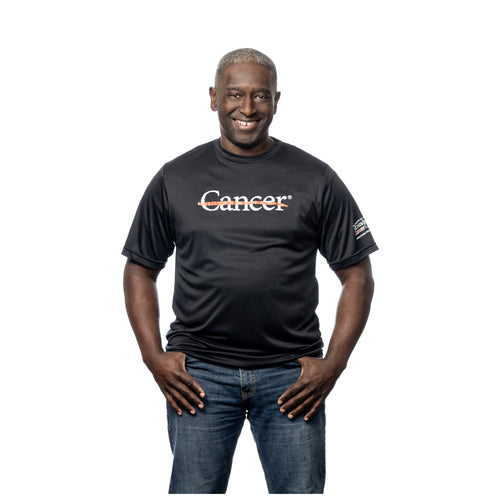 MD Anderson employee wearing a black dri-fit shirt with the white cancer strikethrough logo on the front and the full white MD Anderson logo on the sleeve.