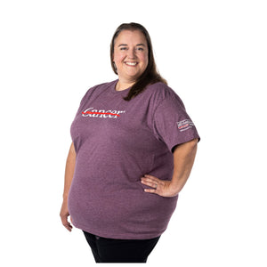 MD Anderson employee wearing a heather maroon shirt featuring the white cancer strikethrough logo on the chest and the white  MD Anderson logo on the sleeve.