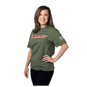 MD Anderson employee wearing a military green shirt featuring the white cancer strikethrough logo on the chest and the white MD Anderson logo on the sleeve.