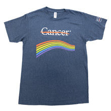 Blue denim shirt featuring the white cancer strikethrough logo with a rainbow underneath and the white MD Anderson logo on the sleeve.