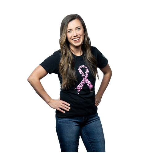 MD Anderson employee wearing a black shirt with a pink cancer ribbon made of hearts on the chest, featuring the MD Anderson logo on the sleeve.