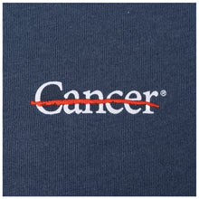Close-up of white cancer strikethrough logo on the chest area.