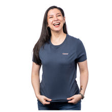 MD Anderson employee wearing a heather navy BELLA+CANVAS shirt featuring the white cancer strikethrough logo on the left upper chest area.