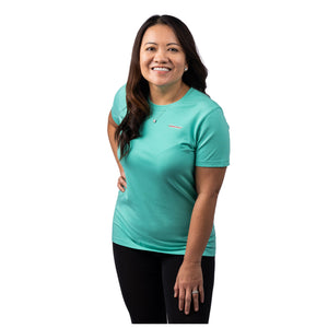 MD Anderson employee wearing a turquoise shirt with white cancer strikethrough logo on the chest area.