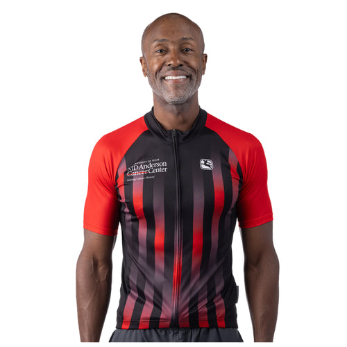 MD Anderson employee wearing a red and black cycling jersey featuring the white MD Anderson logo on the upper right chest area and the white GIORDANA logo on the upper left chest area.