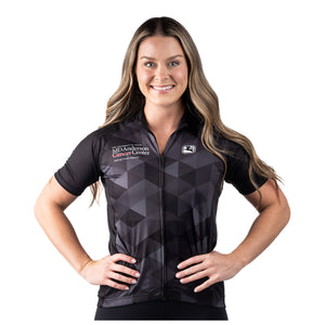 MD Anderson employee wearing a black cycling jersey with a gray grid pattern featuring the white MD Anderson logo on the upper right chest area and the white GIORDADA logo on the upper left chest area.