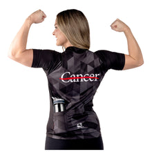 MD Anderson employee modeling the back of black cycling jersey featuring the white cancer strikethrough logo at the top and the GIORDANA logo at the bottom.