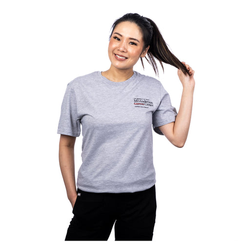 MD Anderson employee wearing a gray shirt featuring the full white MD Anderson logo on the upper left chest area.