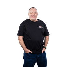MD Anderson employee wearing a black short-sleeve t-shirt featuring the white UT MD Anderson logo on the left chest area.