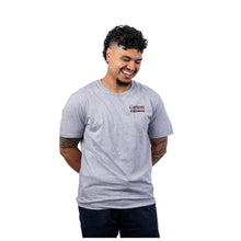 MD Anderson employee wearing a sport gray short-sleeve t-shirt with the black UT MD Anderson logo printed on the left chest area.