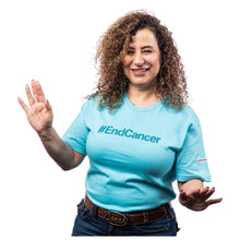 MD Anderson employee wearing a caribbean blue shirt featuring the tagline #EndCancer in darker color with the white cancer strikethrough logo on the sleeve.