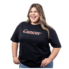 MD Anderson employee wearing a black t-shirt featuring the white cancer strikethrough logo.