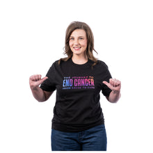 MD Anderson employee wearing a black shirt featuring the multicolor gradient tagline "The Journey to End Cancer from Cause to Cure".
