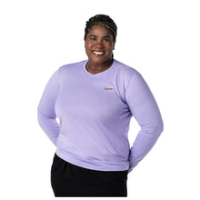 MD Anderson employee wearing a long-sleeve lavender BELLA+CANVAS shirt featuring the black cancer strikethrough logo on the upper left side of the chest area.