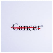 Closeup of black cancer strikethrough logo.