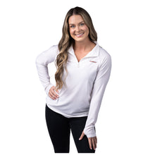 MD Anderson employee wearing a white long sleeve 1/4 zip featuring the black cancer strikethrough logo on the top left chest area.