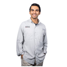 MD Anderson employee wearing a Columbia button up shirt featuring the black MD Anderson logo on the upper right chest area and the Columbia logo on the upper left chest area with front chest pockets.