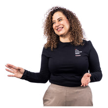 MD Anderson employee wearing a black long sleeve tee featuring the white tagline "Only Possible Here" and the white cancer strikethrough logo on the top left chest area.