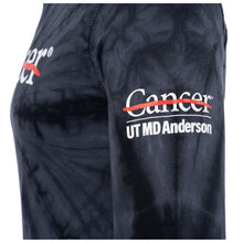 Side view of black long sleeve tie-dye shirt featuring the white cancer strikethrough logo on the chest and the white UT MD Anderson logo on the sleeve.