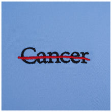 Closeup of black cancer strikethrough logo.