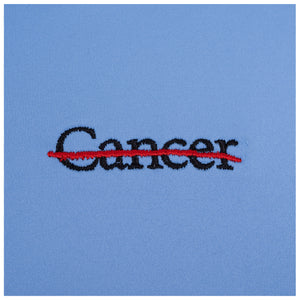 Closeup of black cancer strikethrough logo.