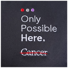 Closeup of white tagline "Only Possible Here" and the white cancer strikethrough logo.