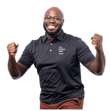 MD Anderson employee wearing a black Peter Millar polo featuring the white tagline "Only Possible Here" and the white cancer strikethrough logo on the top left chest side.