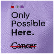 Closup of the tagline "Only Possible Here" and the black cancer strikethrough logo.