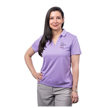 MD Anderson employee wearing a lavender Nike polo featuring the tagline "Only Possible Here" and the black cancer strikethrough logo on the top left chest area.