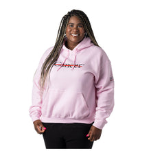 MD Anderson employee wearing a pink hoodie featuring the black cancer strikethrough logo in the middle and the full black MD Anderson logo on the sleeve.