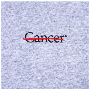 Closeup of black cancer strikethrough logo.