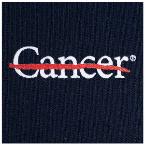 Closeup of white cancer strikethrough logo.