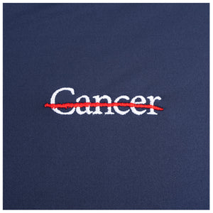 Closeup of white cancer strikethrough logo.