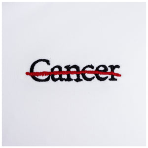 Closeup of black cancer strikethrough logo.