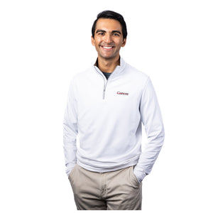 MD Anderson employee wearing a white Peter Millar 1/4 zip featuring the black cancer strikethrough logo on the upper left chest area.