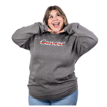 MD Anderson employee wearing a heather gray crewneck featuring the white cancer strikethrough logo in the middle.