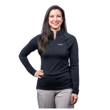 MD Anderson employee wearing a black Peter Millar 1/4 zip featuring the white cancer strikethrough logo on the upper left chest area.
