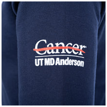 Side view of the navy crewneck featuring the full white UT MD Anderson logo on the sleeve.
