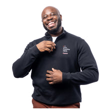 MD Anderson employee wearing a black 1/4 zip featuring the tagline "Only Possible Here" and the white cancer strikethrough logo on the upper left chest area.