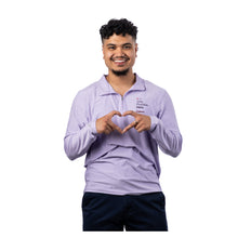 MD Anderson employee wearing a lilac long-sleeve 1/4 zip pullover featuring the "Only Possible Here" tagline and the black Cancer strikethrough logo on the left chest.