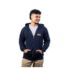 MD Anderson employee wearing a navy blue long-sleeve full-zip fleece hoodie, featuring the white Cancer strikethrough logo and UT MD Anderson text on the left chest.