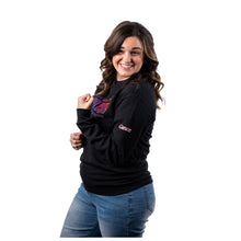 MD Anderson employee wearing a black long-sleeve shirt with a colorful "The Journey to End Cancer" graphic across the chest and the white Cancer strikethrough logo on the sleeve.