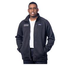 MD Anderson employee wearing a black Patagonia fleece jacket with full zip featuring the white MD Anderson logo on one side and the Patagonia logo on the other side.