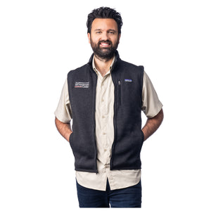 MD Anderson employee wearing a black Patagonia sweater vest with full zip featuring the white MD Anderson logo on one side and the Patagonia logo on the other side.