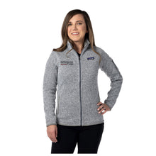 MD Anderson employee wearing a gray Patagonia jacket featuring the black MD Anderson logo on the upper right and the Patagonia logo on the upper left areas.