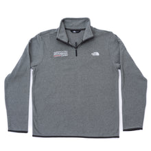 Gray North Face fleece jacket featuring the white MD Anderson logo on the right side of the chest and the white North Face logo on the left side of the chest, featuring a quarter-zip.