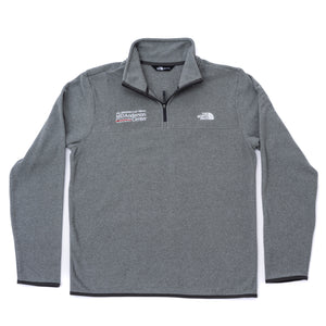 Gray North Face fleece jacket featuring the white MD Anderson logo on the right side of the chest and the white North Face logo on the left side of the chest, featuring a quarter-zip.