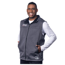 MD Anderson employee wearing a gray North Face fleece vest with a full zipper and front zippered pockets, featuring the white MD Anderson logo on the right chest area and the white North Face logo in the corner.