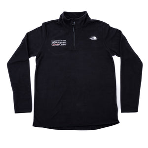 Black quarter-zip North Face jacket with the white MD Anderson logo featured on the right side of the chest, and the white North Face logo on the left side of the chest.