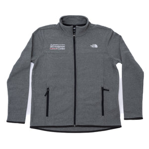 Gray North Face jacket with a full zip in the middle, featuring the white MD Anderson logo on the right side of the chest, and the white North Face logo on the left side of the chest.